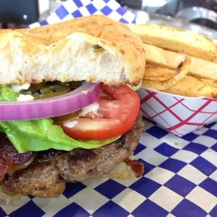 OMG burger with jalapeño bun, bacon, jalapeños and seasoned fries!
