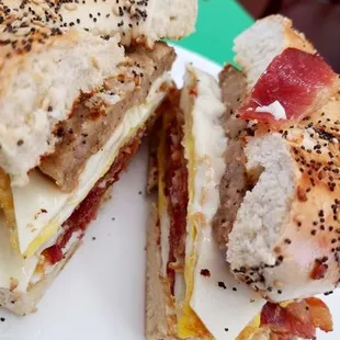 bacon and sausage egg and cheese on an everything bagel