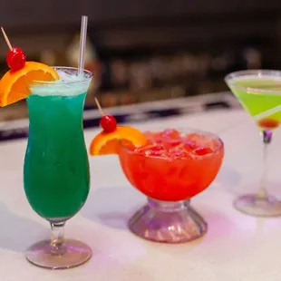 three cocktails on a bar