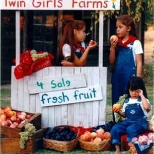 two girls selling fresh fruit