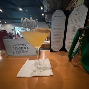 Caramel Apple Martini with drink menu in the background