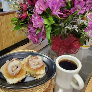 a plate of cinnamon rolls and a cup of coffee