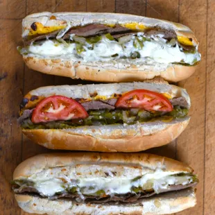 three hot dogs on a wooden table