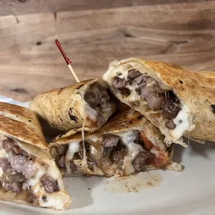 a burrito cut in half on a plate