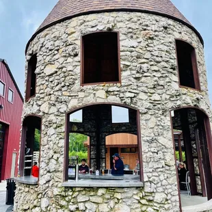 a stone building with a round window