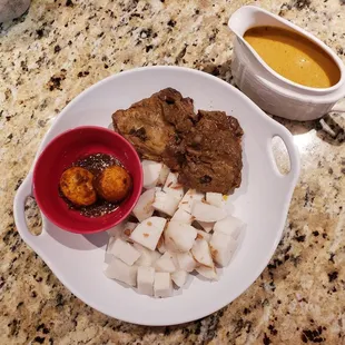 Lontong sayur gule ayam which is hard-boiled rice with chicken and veggy and a curry broth.