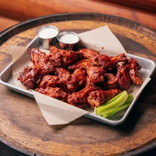 a tray of wings and celery