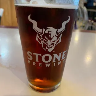 a pint glass of stone brewing