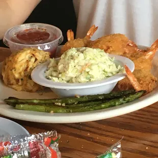 Crab cakes, fried shrimp, asparagus, coleslaw, and cock tail sauce