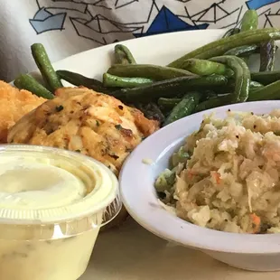 Crab cakes, green beans, and coleslaw. TarTar sauce pictured bottom left