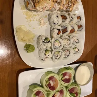 two plates of sushi and a glass of beer