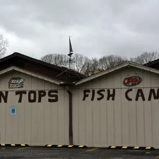 two garages with a sign that says twin tops fish camp