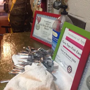 This is a great sign at any restaurant.  Hand sanitizer next to the silverware rolling station.
