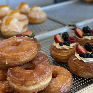 a variety of donuts on a cooling rack