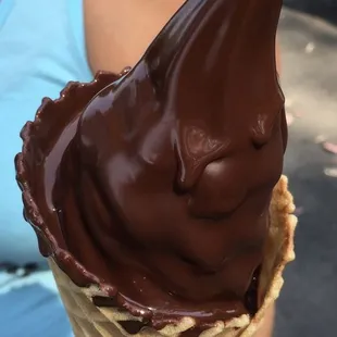 Soft serve ice cream with signature chocolate dip in a waffle cone
