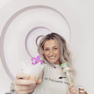 a woman holding a cupcake