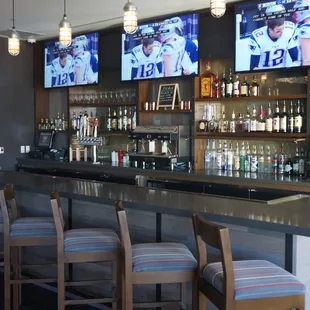 a bar with multiple televisions
