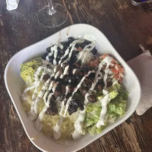 a plate of salad and a glass of wine