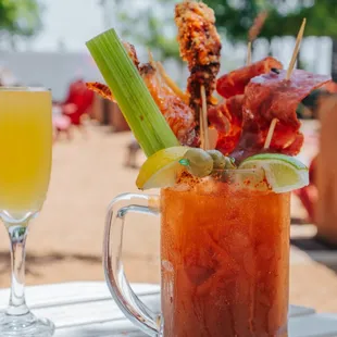 a bloody drink and a glass of orange juice