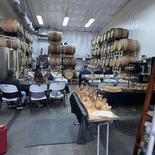 people sitting at tables in a wine cellar