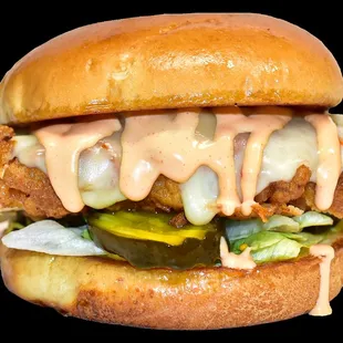 a chicken sandwich with cheese and pickles