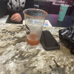 a man sitting at a bar with a drink in front of him