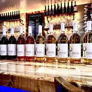 bottles of wine lined up on a bar