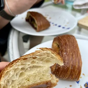 Traditional croissant with a pan suisse in the background
