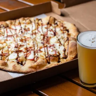 a pizza and a glass of beer