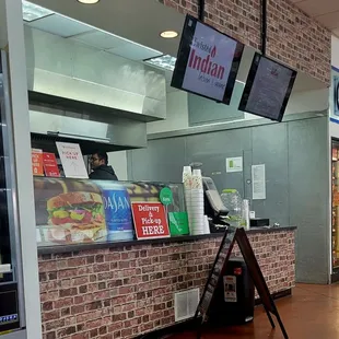 a restaurant counter with a brick wall