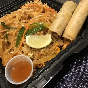 Pad Thai with tofu and an order of spring rolls with sauce.