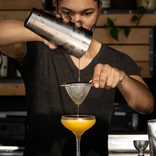 a bartender pouring a drink