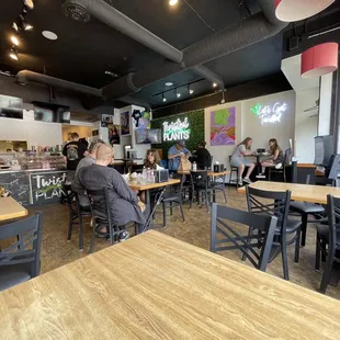 people sitting at tables in a restaurant