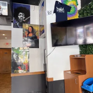 a wall with posters and a television