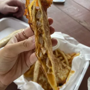 a person holding a sandwich