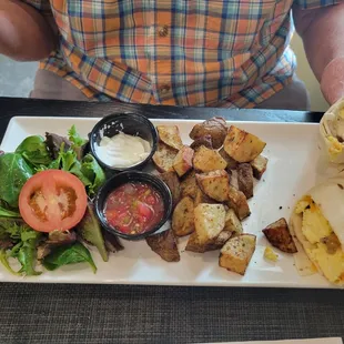 Sausage, egg, and cheese burrito with roast potatoes and salad