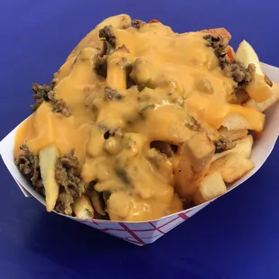 the cheeseburger fries in a paper container