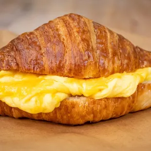 Toasted croissant sandwich, with fluffy scrambled eggs and sharp cheddar cheese