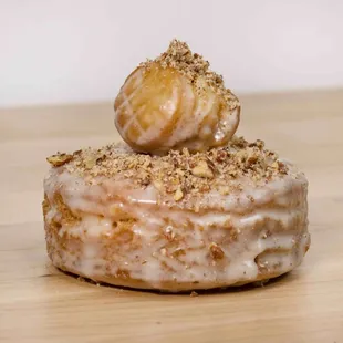 a glazed donut on a wooden table