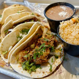 a plate of tacos and rice