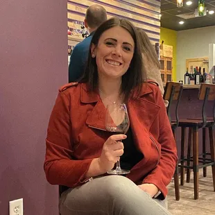 a woman holding a glass of wine