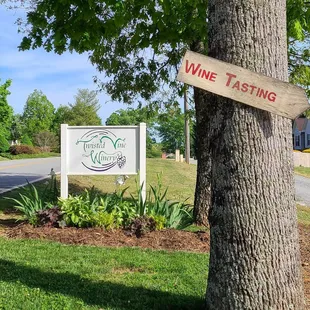 a sign in front of a tree