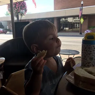 a child eating a sandwich