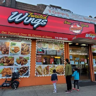 a woman and a child outside a restaurant