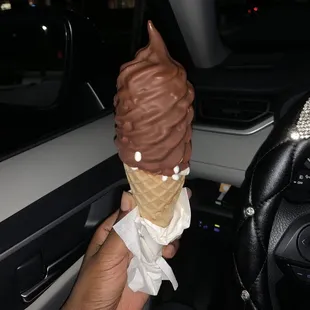 Small waffle cone, coconut ice cream and chocolate dipped!