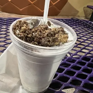 a close up of a smoothie in a plastic cup