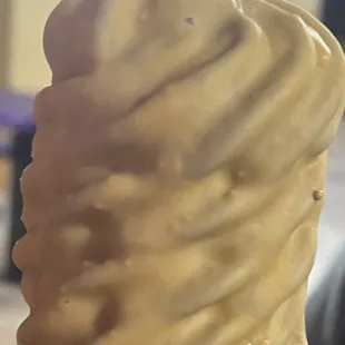 a hand holding a cone of ice cream