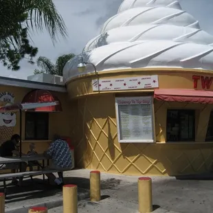 a large ice cream cone sitting in front of a restaurant