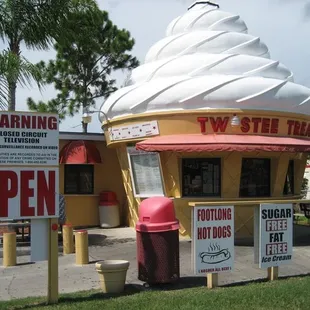 an ice cream shop with a cone on top