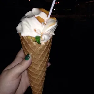 Vanilla &amp; orange soft serve in a waffle cone with gummy bears
